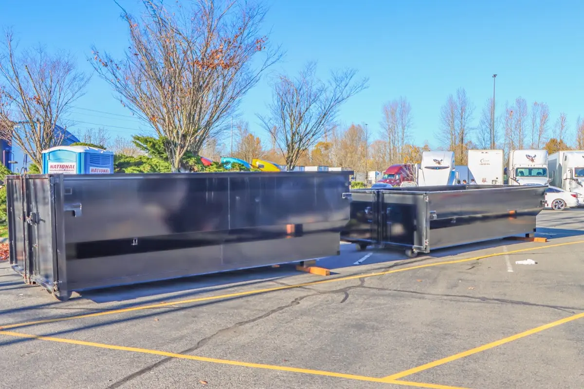 Professional dumpster rental service with roll-off container on residential driveway in Short Pump